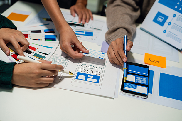 Team designing a mobile app interface prototype.