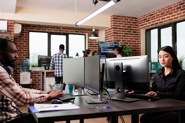 Developers working on code in a modern office space.