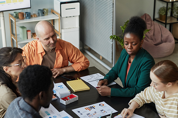 Diverse team collaborating on a project at a table.