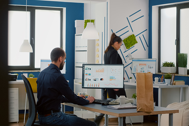 Man analyzing data on computer in modern office.